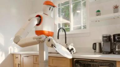 Sunday AI's Memo robot holds a plate in the kitchen and prepares to place it in the dishwasher