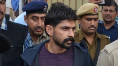 Gangster Lawrence Bishnoi is escorted by police personnel before being produced in Panchkula Court, on November 13, 2019 in Panchkula, India. Notorious gangsters Lawrence Bishnoi and Sampat Nehra and their aides were produced in a Panchkula district court amid tight security for framing of charges in two criminal cases that took place in 2017.