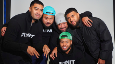 Founders of 'Run It Straight' Stephen Hancock, Virgil Tauaa, Brendan Tauaa, Brandon Tauaa, Noel Tauaa, Darren Hancock, and Rennie Molimau. The group of young men are all wearing dark colours, with tops with Run It written in white capitals on their tops. Three are wearing caps of various colours, they all have beards.