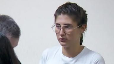 Bella Culley filmed in court. She is wearing glasses and has brown hair in a plait and is wearing a white top