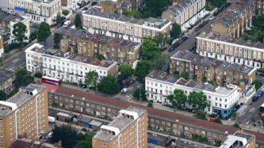 An aerial shot of tower blocks and houses