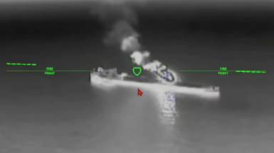 A still image of an oil tanker under attack from a drone in a black and while nighttime image