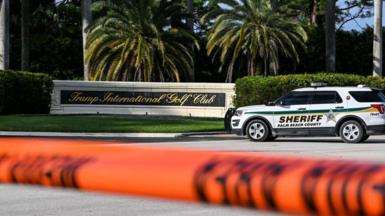 A sheriff's car blocks the street outside the Trump International Golf Club in West Palm Beach, Florida, on September 15, 2024 following a shooting incident at former US president Donald Trump's golf course.