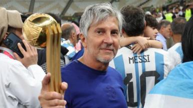 Jorge Messi holding his son Lionel Messi's trophy for best player at the 2022 World Cup after Argentina beat France in the final in Qatar