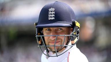 Joe Root smiles under his dark blue helmet