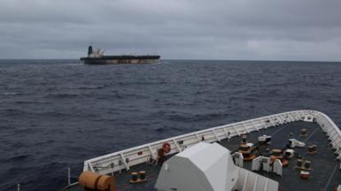 The shadow fleet ship Marinera seen in the distance from the upper decks of a US coastguard cutter following her.