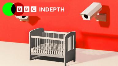 A illustration shows a baby’s cot against a bright red background. Above the cot, two white CCTV cameras are mounted on the wall, pointing towards the cot.