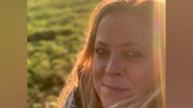 Annabel Rook, a woman with blonde hair, turns to look at the camera in low sun