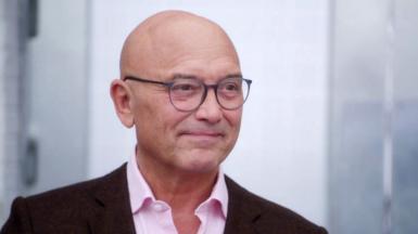 Gregg Wallace in pink shirt and brown/maroon jacket 