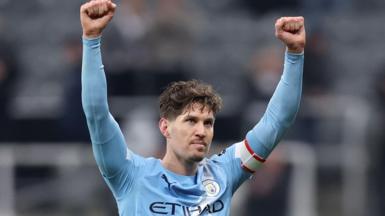 Manchester City defender John Stones celebrates with arms aloft after his side's FA Cup win over Newcastle United