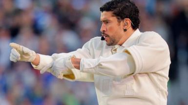Puerto Rican rapper Bad Bunny points with both hands during in his performance at the Super Bowl