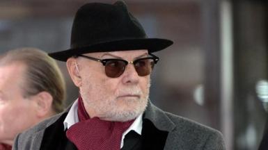 Gary Glitter pictured in 2015 wearing a trilby and sunglasses