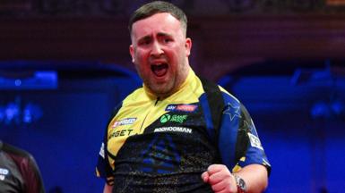 Luke Littler celebrates his nine-darter at the Winter Gardens in Blackpool