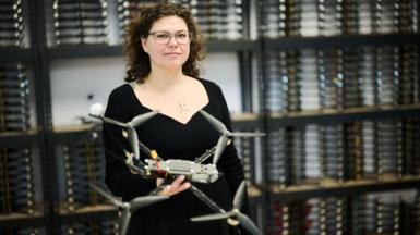Kseniia Kalmus holding one of her drones