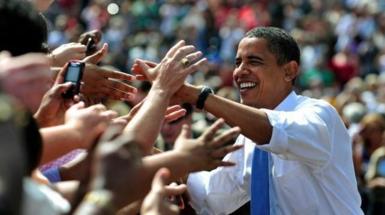 Barack Obama greets voters, their hands reaching towards him, at a rally during 2008 presidential campaign