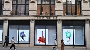 People walking past a luxury department store in Knightsbidge, London 