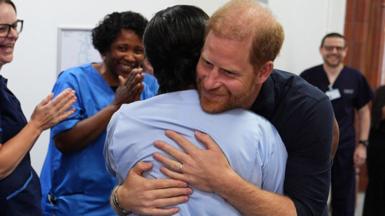 Prince Harry hugs a nurse on his visit to Birmingham Children's Hospital