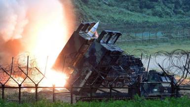 an ATACMS rocket is fired from a launcher with flames in the background - south Korea defence ministry handout, 2017 