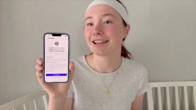 Teenage girl holding up phone with her blocked Instagram account