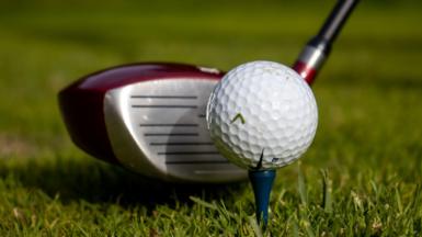 Picture showing golf driver next to a golf ball on a tee