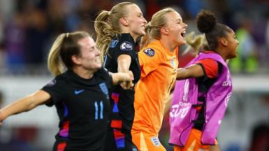 Several of England's women hold hands and run in a line smiling after beating Italy in the Euros semi-final