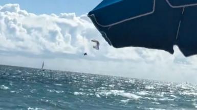 paraglider falling into the ocean
