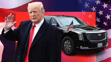 Donald Trump waves as his black, bulletproof car is seen behind him with small USA flags attached to the bonnet.  