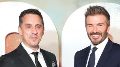 Gary Neville and David Beckham dressed in suits at the premiere of 99
