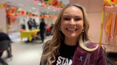 A woman smiles at the camera