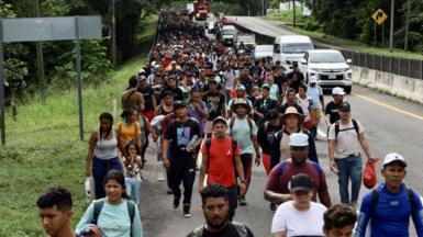 Migrants advance in caravan on their way to the US through Huehuetan, Mexico, last week