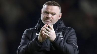 Plymouth Argyle manager Wayne Rooney sheepishly applauds the away support