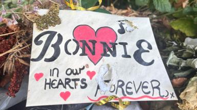 A sign reading Bonnie in our hearts forever