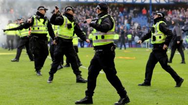 Police on the pitch at Ibrox