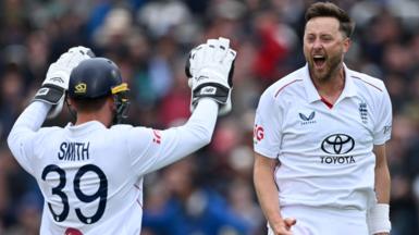 England cricketers Ollie Robinson and Jamie Smith celebrate a wicket