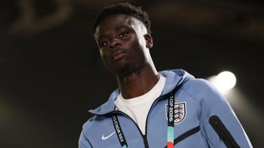 Bukayo Saka in a pale blue England tracksuit