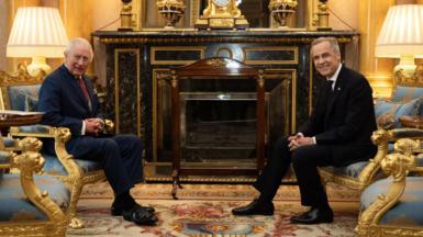 King Charles poses for a photo with Mark Carney