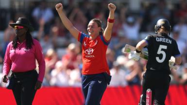Dani Gibson raises her hands in the air to celebrate the wicket of Maddy Green