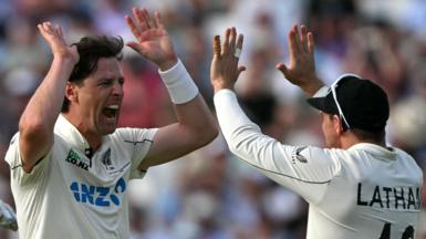 New Zealand bowler Matt Henry (left) celebrates taking a wicket with captain Tom Latham (right)