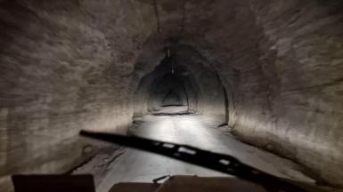 One of the tunnels leading into the depths of Birkshead drift mine. The image has been taken from inside a vehicle, looking out to the tunnel.