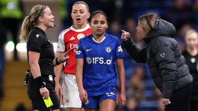 Sonia Bompastor, Manager of Chelsea, reacts in front of Katie McCabe and Alyssa Thompson after being shown a yellow card by referee Frida Mia Klarlund 