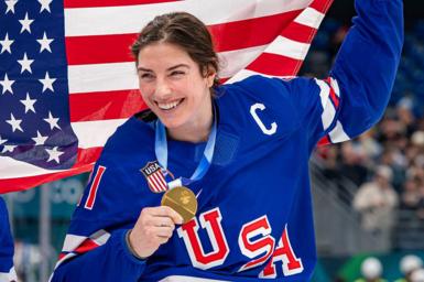 Hilary Knight poses with her medal at the Olympic rink