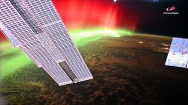 Aurora lights are seen around Earth's surface from the International Space Station.