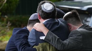 Worshippers gather near the scene of the attack