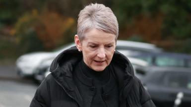 Lady Donaldson, a woman with grey hair, wearing a black coat and black top.