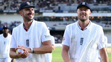Josh Tongue and Ollie Robinson smile as they walk off the field together