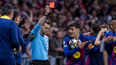 Referee Clement Turpin sends off Eric Garcia during Barcelona's Champions League second leg against Atletico Madrid in 2026 while his team-mate Pedri protests