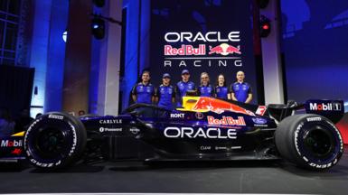 Left to right: Red Bull technical director Pierre Wache, drivers Isack Hadjar and Max Verstappen, team principal Laurent Mekies, F1 Acadmey driver Alisha Palmowsk and technical operations director Phillip Prew pose with a show car in Red Bull''s new livery
