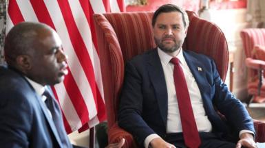 Vance and Lammy sit in red armchairs during a press conference at Chevening House, in Chevening, southeast England