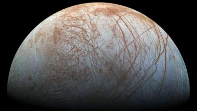 The puzzling, fascinating surface of Jupiter's icy moon Europa looms large in this view made from images taken by NASA's Galileo spacecraft in the late 1990s.