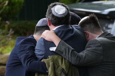 Worshippers gather near the scene of the attack